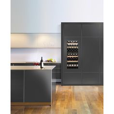 a modern kitchen with stainless steel appliances and wood flooring