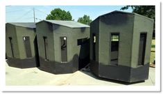 there are three black toilets on the sidewalk