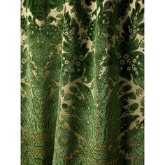 a green and white curtain with an intricate design