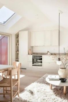 a living room filled with furniture and a skylight