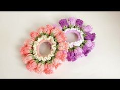 three crocheted flower wreaths sitting next to each other