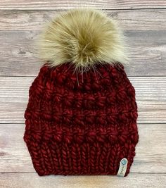 Luxury teen or adult beanie made with Malabrigo Rasta yarn and topped with a large faux fur Pom which is removable. This is a beautiful deep red color called Pagoda with exquisite texture to keep you warm and cozy! Made with 100% merino wool this is a luxury beanie that will last a long time, and fits generously all adult sizing head circumference 18-23." This the Abalone beanie pattern @woolandknits. Hand wash only in cold water and lay flat to dry. Remove Pom before washing. This would make a Fitted Yarn Beanie For Winter, Fitted Winter Beanie Made Of Yarn, Warm Red Crochet Hat For Fall, Red Crochet Beanie For Fall, Winter Fitted Yarn Beanie, Red Crochet Hat For Winter, Cozy Red Beanie For Fall, Red Crochet Hat For Winter Cold Weather, Cozy Red Hat For Cold Weather