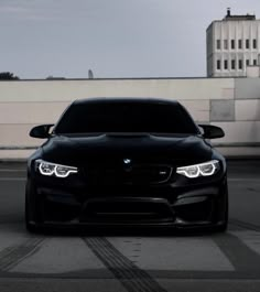 the front end of a black bmw car