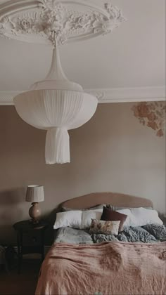 a bed sitting in a bedroom next to a lamp