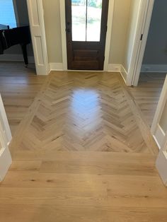 an empty room with wooden floors and doors