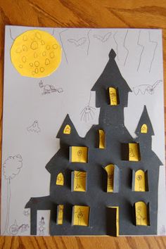 a paper cut out of a castle with bats on it