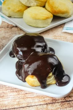 two chocolate covered pastries on a white plate