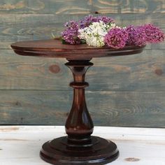 a wooden stand with flowers on it