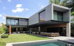 a large modern house with a pool in the foreground