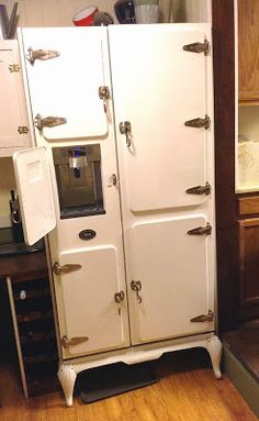 an old fashioned white refrigerator in a kitchen