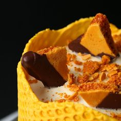 a yellow cake with chocolate and cream toppings