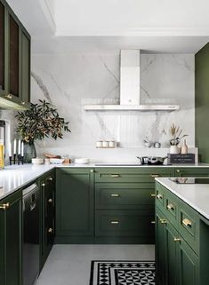 a kitchen with green cabinets and white counter tops