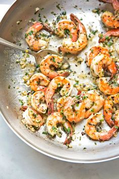 cooked shrimp with parsley and garlic in a skillet