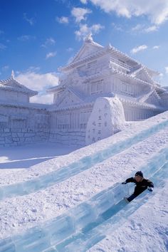 a man is snowboarding down a snowy hill