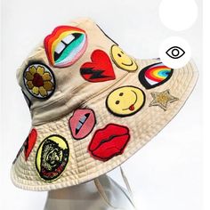 a hat with patches on it sitting on top of a white headdress mannequin