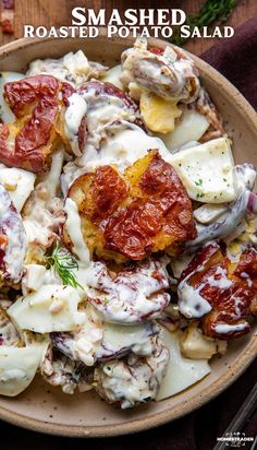 a bowl filled with potato salad on top of a wooden table