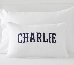 a white pillow with the word charlie on it