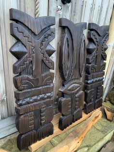 three carved wooden sculptures sitting next to each other