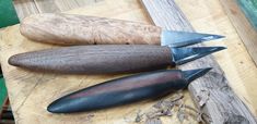 three different types of knives on a wooden table