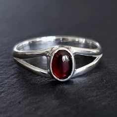 💖  Product Description Dainty Garnet Ring - Oval 925 Sterling Silver Garnet Ring Garnet is the January Birthstone and 2nd Anniversary Gemstone 💖 Product Details *  925 Sterling Silver *  Handmade *  Total Ring Length - 8mm *  Stone Size - 7mm x 5mm *. Stone Height - 3mm *  Weight - 2.8g *  Band Width - 3mm 💖 Ring Sizing If you're unsure of your finger size, please purchase the reusable plastic ring sizers we have available and follow the instructions in the FAQ section to determine your finger size.  Please note your knuckle size too.   US Sizer - https://www.etsy.com/uk/listing/1122628075/ring-sizer-us-us-sizes-1-17-free UK Sizer - https://www.etsy.com/uk/listing/1108679592/ring-sizer-uk-uk-sizes-a-z9-free If you prefer not to buy a ring sizer, please refer to the Sizing Guide in the F Red Gemstone Jewelry, Garnet Sterling Silver Ring, Silver Garnet Ring, 2nd Anniversary Gift, Garnet Ring Silver, Sterling Silver Garnet Ring, Supernatural Dr, Alternative Jewelry, Everyday Ring