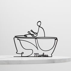 a metal sculpture of a person in a bathtub with the word maksu on it