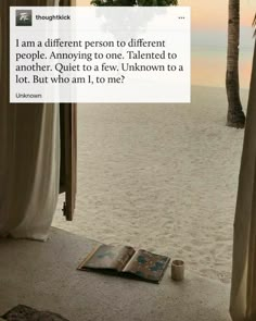 an open book sitting on top of a sandy beach