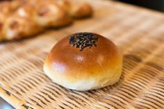 a piece of bread with black sprinkles on it sitting on a wicker tray