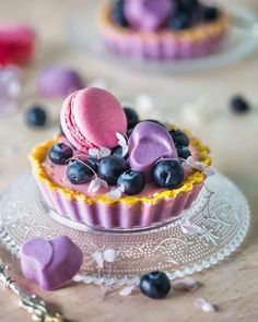 there is a small cupcake with blueberries on it