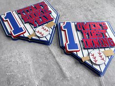 two baseball themed coasters sitting on top of a cement floor next to each other