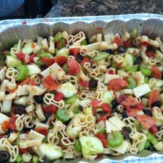 a pan filled with pasta salad on top of a counter