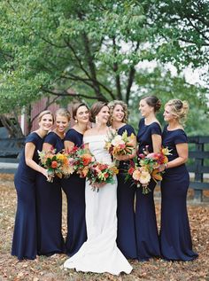 a bride and her bridesmaids in navy blue dresses