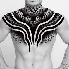 a man with tattoos on his chest is posing in front of a white background and black and white photo