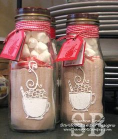 two mason jars filled with hot chocolate and marshmallows