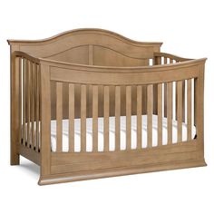 a wooden baby crib with white sheets on the bottom and side rails, in front of a white background