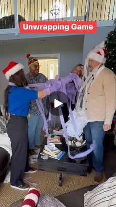 group of people in christmas hats playing with an interactive video game on the nintendo wii