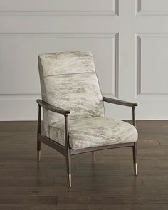 a white chair sitting on top of a hard wood floor