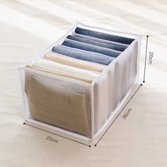 the drawer is filled with folded clothes and has four pockets to store them on it