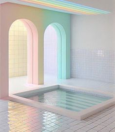 an empty room with a pool in the middle and rainbow colored arches on the wall