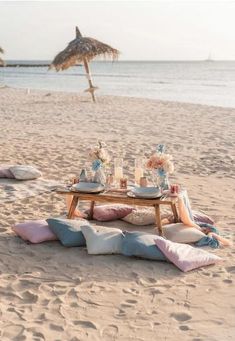 a table set up on the beach for a picnic