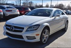 a white mercedes cls parked in a parking lot