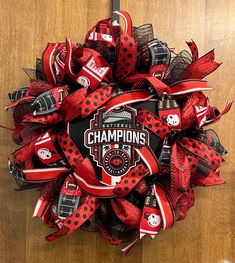 a red and black hockey wreath with the words champs on it