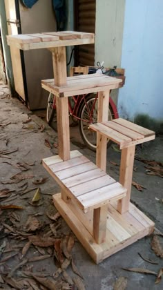 a wooden bench sitting next to a bike