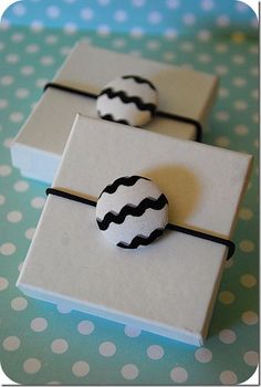 two small white and black buttons sitting on top of a book