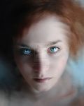 a blurry photo of a woman with blue eyes