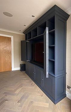 a large entertainment center in an empty room