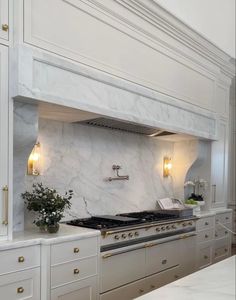 a kitchen with marble counter tops and white cabinets