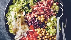 a plate filled with lots of different types of food on top of a black table