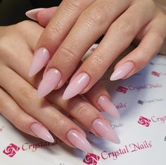 a woman's hands with long pink nails