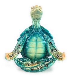 a statue of a turtle sitting in the middle of a yoga position with its eyes closed