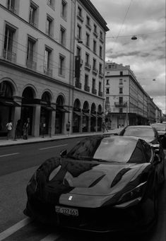 a black and white photo of a car parked on the street